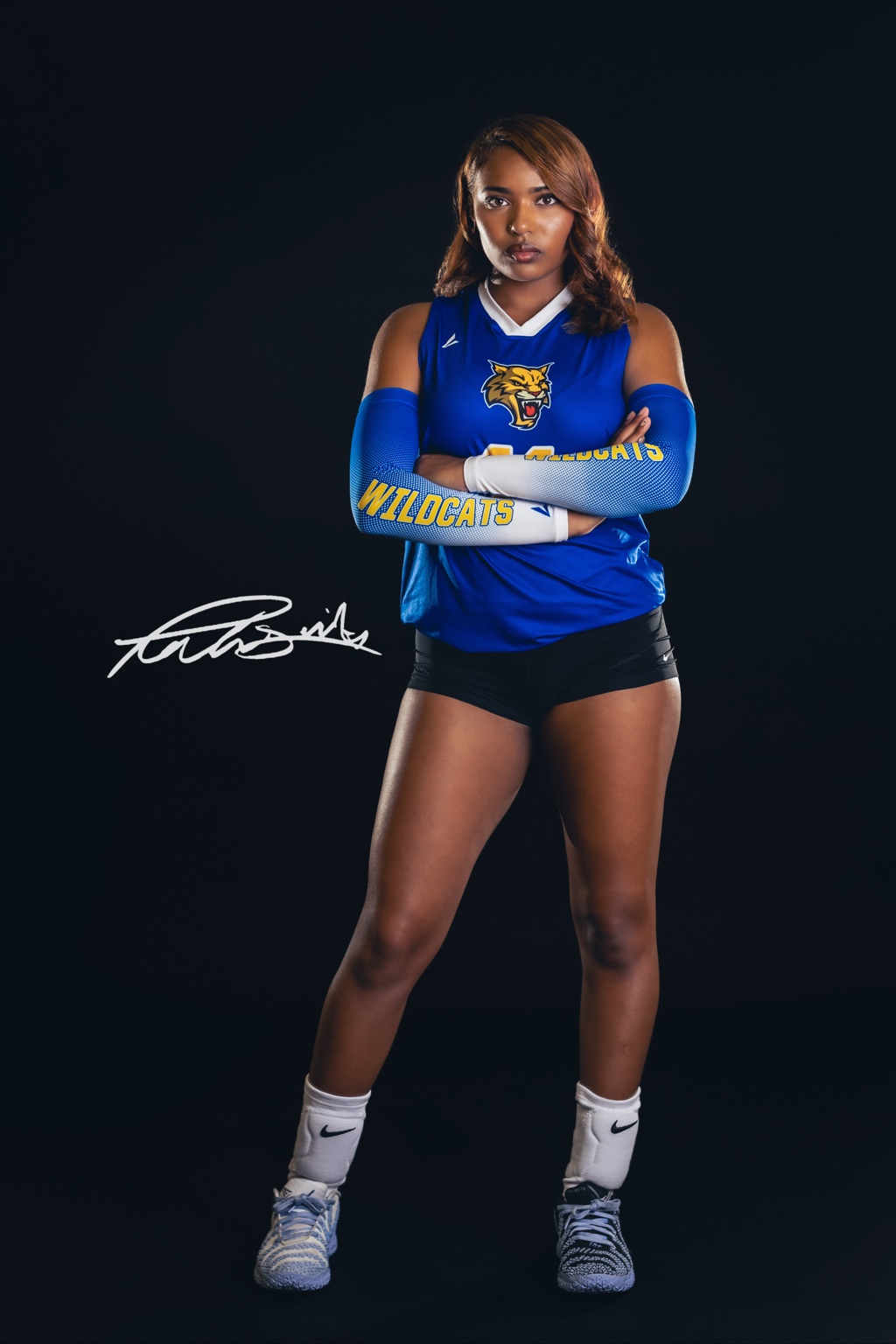 Will C. Wood athlete in a blue jersey, arms crossed, against a black studio backdrop