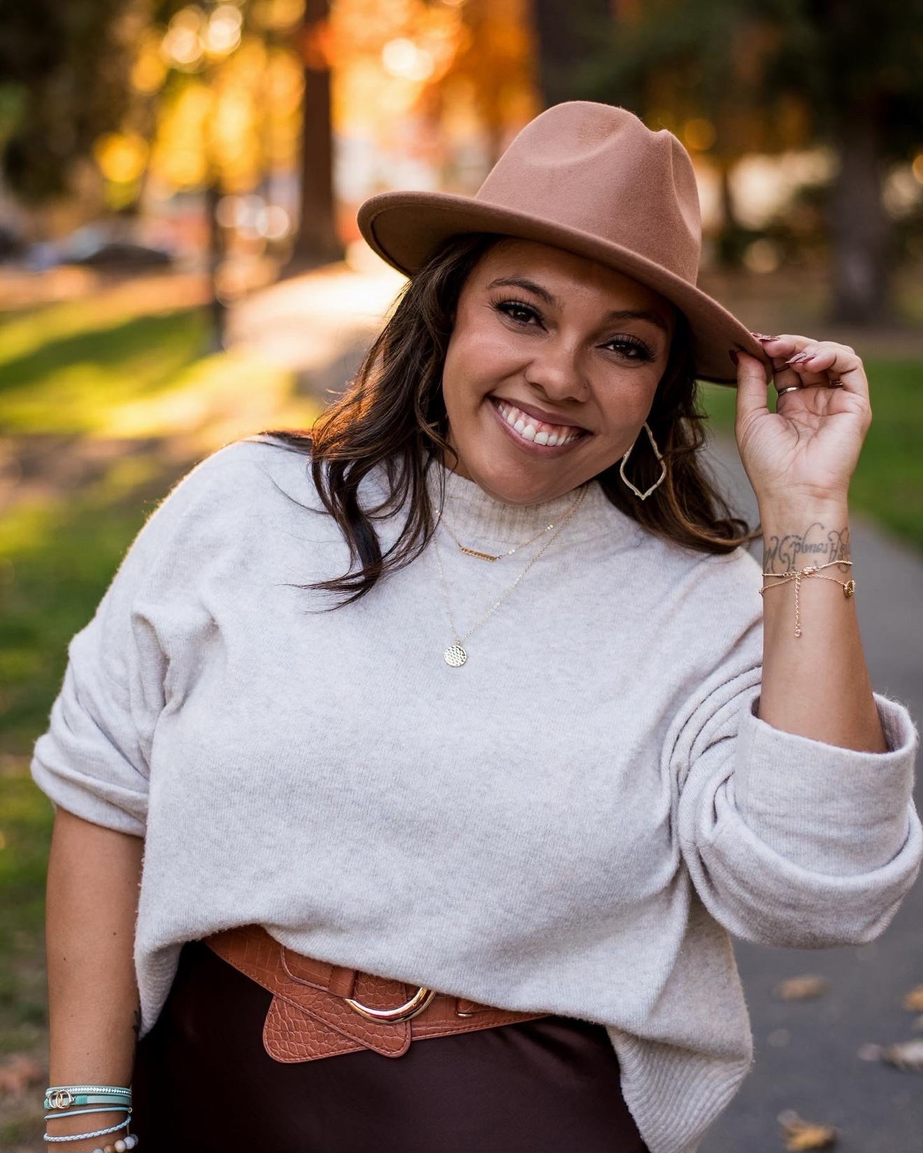 Sheree Rayford, outdoor portrait wearing a tan hat and cream sweater